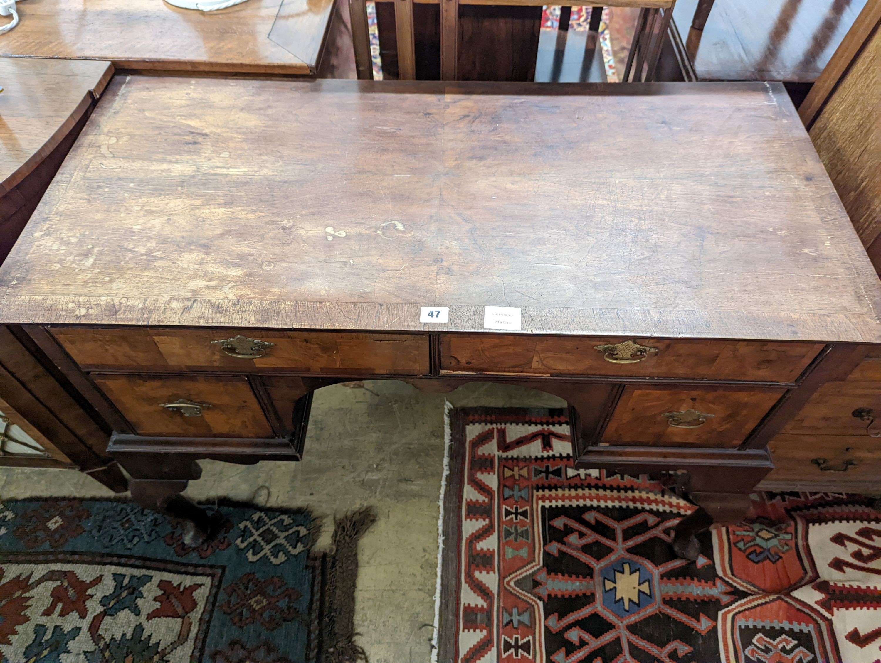 A Queen Anne revival banded walnut kneehole dressing table, width 102cm, depth 48cm, height 75cm